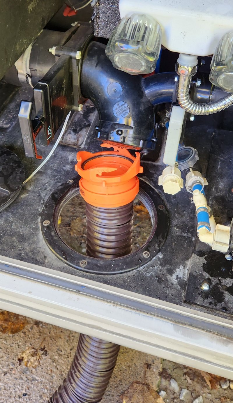 Remove the cap from your trailer's drain pipe and attach your sewer drain hose